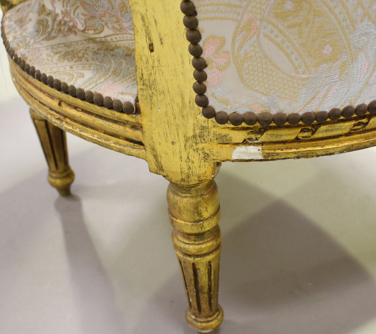 A pair of 20th century Louis XVI style giltwood showframe tub back armchairs, upholstered in foliate - Image 2 of 5