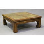 A South-east Asian square oak framed coffee table, the top inset with four panels of rattan,