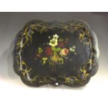 A Victorian papier-mâché tray of serpentine outline, painted with a central spray of flowers