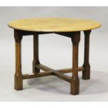A George V Arts and Crafts style oak circular occasional table, on chamfered block legs, height
