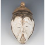 An African carved and painted wooden mask with upward turned mouth, height 34cm.Buyer’s Premium 29.