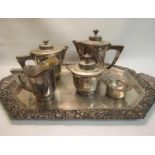 A Spanish silver six piece tea service comprising a two handled tray, teapot, water jug, milk jug,
