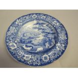 A blue and white pearlware soup plate with figures and cattle in foreground and house and park in