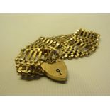 A substantial 9ct gold gate bracelet with heart padlock. Approx 23g