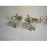 A pair of Edwardian Art Nouveau influenced three handled bowls on stands, makers mark for Horace