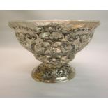 A late Victorian fruit bowl of pierced foliate and scroll form with a moulded glass liner, makers