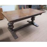 A late 18c/early 19c Dutch oak extending dining table of plank form supported on bold baluster