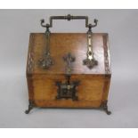 A 19c oak stationery box with strap hinging, central carrying handle over a hinged cover fitted