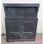 A late 17c/early 18c oak court cupboard of simple early design with drop finials, the top fitted two
