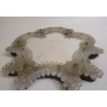 A late 19c/early 20c Venetian serpentine mirror decorated with a border of opaque glass beaded