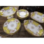 A Coalport yellow bats wing dessert service comprising twelve 23cm plates, comport 15cm h, pair of