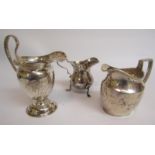 Three silver creamers, Chester 1909, 7cm h, George Unite with makers mark rubbed 8cm h and one of