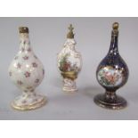 A collection of three 19c Continental porcelain perfume bottles, one of scrolling form with gilt