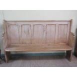 A 19c Welsh five panel high back pine pew with shaped side supports, 197cm w, 124cm h.