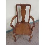 A Howard and Sons walnut open armchair with solid bar splat, shaped and moulded arms on scrolling