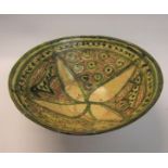 A Persian antique pottery bowl, decorated in incised olive green and brown patterns - with museum