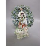 A Derby bocage figure of a shepherdess, a partner to the 'Piping Shepherd', holding a posy and