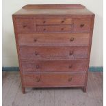 A Heal's oak compendium having four short drawers over four long graduated drawers, all with