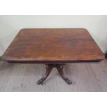 A mid Victorian rectangular tilt top pedestal table, the column bold turned baluster form raised