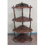 A Victorian figured walnut three tier corner whatnot with marquetry decoration, having reeded
