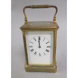 A late 19c French carriage clock in glazed brass case. The 6cm white enamel dial has Roman numerals,