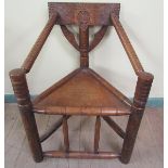 A 19c oak Turners chair of triangular construction, 64cm w, 87cm h.
