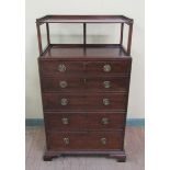 A late Georgian mahogany secretaire chest with upper tier shelf, the secretaire with fall front