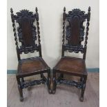 A pair of Carolean style oak high back single chairs, the back with arched carved panel within