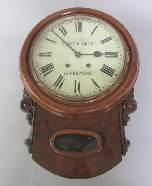 A late Victorian walnut and oak striking drop dial wall clock, the circular bezel with white painted