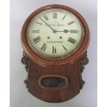 A late Victorian walnut and oak striking drop dial wall clock, the circular bezel with white painted