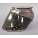 An Edwardian horse's hoof inkwell with silver plated mounts and cover, 12cm w, 8cm h.