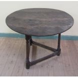An 18c plank top circular cricket table on three ring turned splayed legs with moulded box stretcher