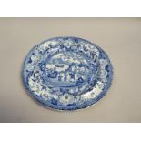 A blue and white plate printed with a scene of an Oriental garden with figures and vase in