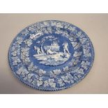 A blue and white plate printed with a Bacchanalian scene of four children and a goat within fruiting