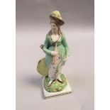 An early 19c square based figure of a lady archer with bow, arrow and target,