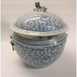 A 19c Chinese tureen and cover decorated in blue scrolling leaf and flowers, the dome cover with dog