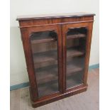 A Victorian mahogany pier cabinet fitted shelves and enclosed by two glazed doors, 93cm w, 122cm h.
