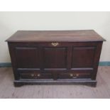 An early 18c oak three panel mule chest fitted candle box and a shallow drawer, over base with two