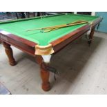 A contemporary mahogany framed snooker table manufactured by Thurston, with snooker and pool balls