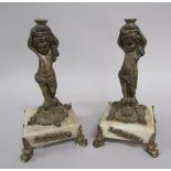 A pair of 19c gilt metal and marble lamp stands, the columns formed by cherubs supporting urns on