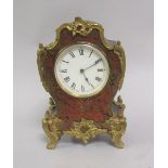 A late 19c/early 20c French style mantel clock, black lacquered and with red boullework face, having