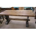 A 19c oak refectory dining table with a heavy four plank top on shaped side supports with moulded