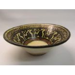 A Persian antique pottery bowl densely decorated in shades of brown and yellow, with museum repairs,