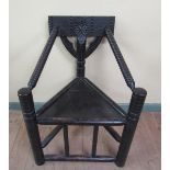 A 19c stained oak Turners chair of triangular construction, 64cm w, 89cm h.