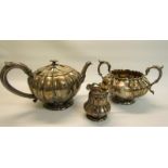A Victorian silver tea service, the lobed globular teapot with makers mark for Richard Sibley II and