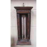 A 19c French thermometer, the painted black and white register within a column arch, 46cm h.