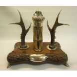 An Edwardian Scottish ink stand composed of a deer's cloven hoof inkwell, silver mounted and with