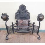 An early 19c cast iron and brass mounted fire grate, the basket with a cast arched back plate and