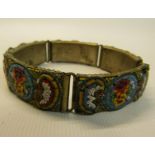 A bracelet set with micro mosaic linked panels decorated with floral designs on white metal panels