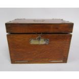 A Victorian oak smokers cabinet fitted with a pipe rack, three compartments with silver plated